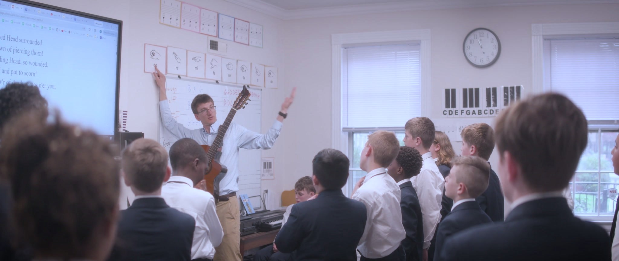A Cathedral teacher leading music class